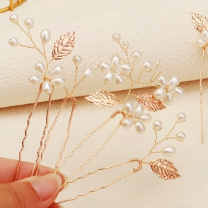 Handmade bridal hair pins set with gold metal leaves and elegant pearls for wedding styling