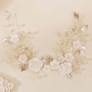 Elegant bridal hair vine with white flowers, silver leaves and pearls for wedding hairstyles