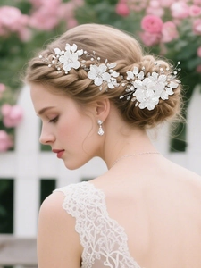 Detailed view of handmade bridal hair comb with white shell flowers and crystals