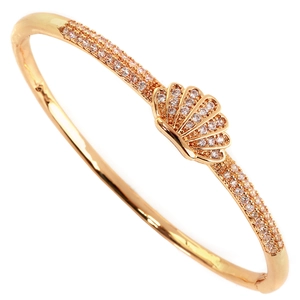 Elegant gold-tone ocean-themed bangle featuring shell charm and white zircon inlay
