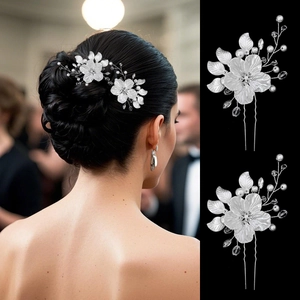 Detail view of handmade bridal hair pins with white shell flowers and crystal accents