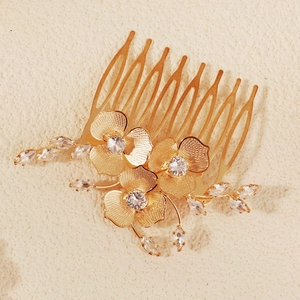 Elegant gold bridal hair comb with floral leaf motifs and clear zircon crystal accents