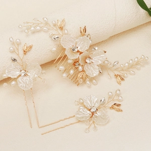 Detail of bridal hair accessories set featuring white shell flowers and crystal beads
