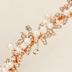 Detail of bridal headband with golden leaves, white pearls and sparkling rhinestones