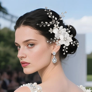 Detail of silver bridal hair comb with white shell flowers and pearl crystals