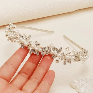 Elegant silver bridal headband with crystal leaves and white pearls for wedding parties