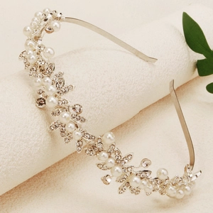 Macro view of silver bridal headband with sparkling rhinestones and white pearls