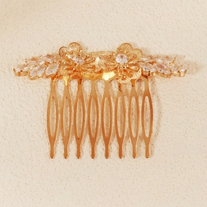 Elegant gold flower bridal hair comb with cubic zirconia petals and polished finish