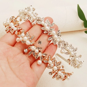Elegant gold bridal headband with pearls and rhinestones in a leaf vine design