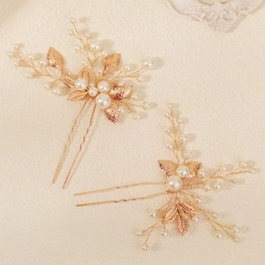 Handmade golden bridal hair pins set with elegant pearl leaves for wedding hairstyling