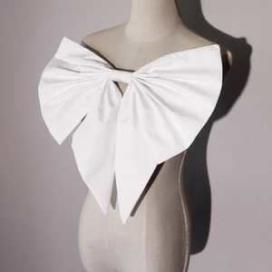 Elegant white oversized bridal bow accessory for wedding dresses shown on a mannequin