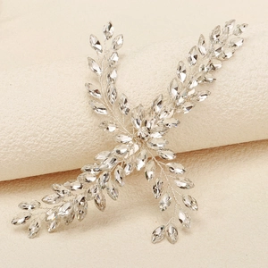 Elegant bridal hair clip with silver wire leaves and marquise crystals on a prop