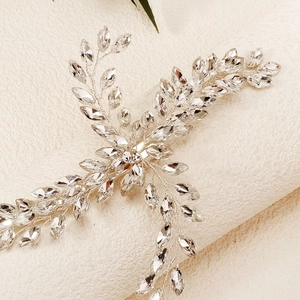 Detailed macro shot of silver wire bridal hair clip with sparkling marquise rhinestones