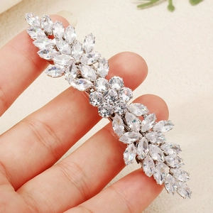 Detailed view of silver hair clip with marquise and round cubic zirconia in floral pattern