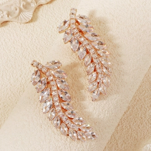 Detail of champagne gold leaf earrings with marquis-cut zircons and polished finish