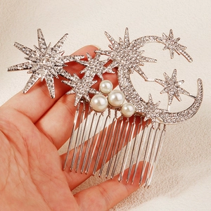 Detailed close-up of crescent moon and star hair comb with sparkling rhinestones and pearls