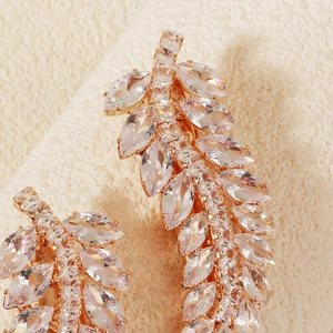 Macro shot of rose gold leaf hair clip featuring brilliant marquise cut zircon stones