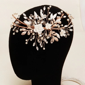 Detail of handmade floral crystal headband with rose gold wire and pearls for weddings