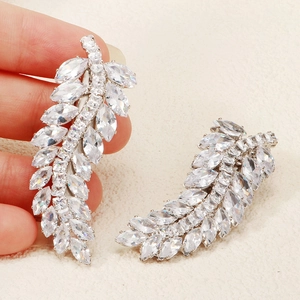 Close-up of sparkling zircon feather hair clips with marquise cut crystals on silver base