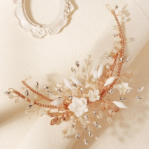 Detail of rose gold bridal hairpiece with ceramic flowers and pearl beads