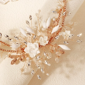 Handmade flower bridal headband with white ceramic petals, pearls, and crystals on gold wire