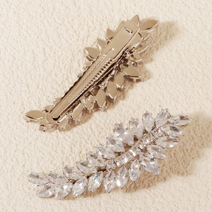 Detailed view showing sparkling zircon leaf hair clips with silver-tone duckbill structure