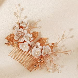Gouden bruidshaarkam met witte bloemen, parels en kristallen bladnerven details