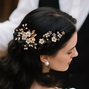 Detail view of handmade bridal hair pins with white resin flowers and pearls on dark hair