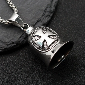 Vintage stainless steel biker bell necklace with embossed cross on black stone background