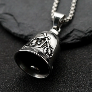 Macro detail of retro stainless steel bell pendant with embossed motorcycle pattern
