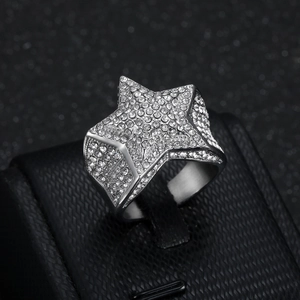 Hip hop silver star ring with shimmering crystals and a wide polished band on a jewelry box
