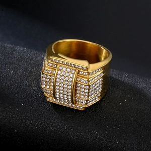 Luxury 316L gold plated stainless steel hip hop ring with paved zircons on black surface