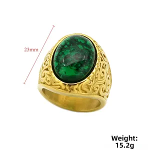 Detail view of vintage men's ring featuring 23mm green gemstone and engraved gold pattern