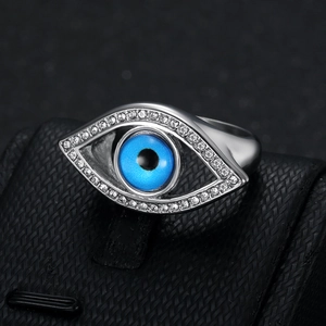 Silver evil eye ring with blue center stone and white crystals on black display