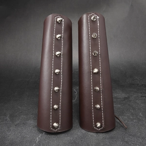 Brown vintage faux leather bracers with silver cone studs and contrast stitching