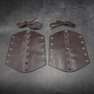 Detail view of dark brown punk leather bracers with metal rivets and lace-up closure