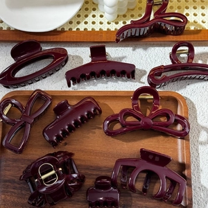 Deep burgundy acrylic hair claws in multiple shapes with strong metal spring mechanisms