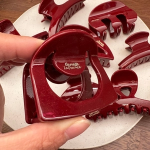 Elegant glossy wine red hair claw clip with golden logo for women hairstyle