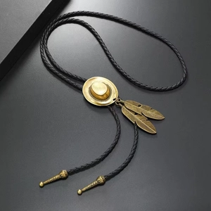 Detail of vintage bronze cowboy hat and feathers on black braided bolo tie cord