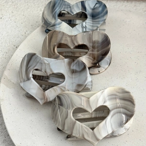 Vintage heart-shaped hair claw clips with ink texture marble patterns in four colors