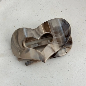 Detailed view of heart-shaped hair claw clip with vintage ink marble pattern finish