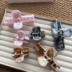 Detail of vintage ink pattern hair claw clips in various sizes and marble textures