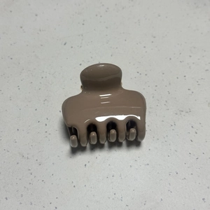 Detail view of mocha brown high gloss hair claw clip with smooth polished surface
