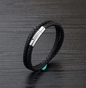 Macro shot of double-layered black braided leather bracelet with stainless magnetic clasp