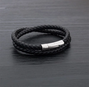 Detail of black woven leather double-wrap bracelet with polished silver magnetic clasp