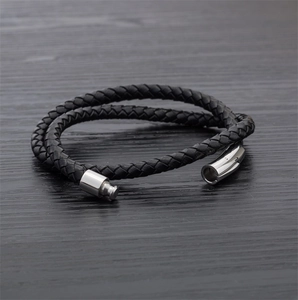 Detail of black braided leather double-wrap bracelet with polished silver clasp