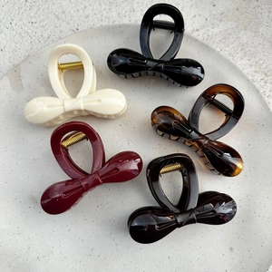 Set of minimalist bow hair clips in five colors on a stone base for women hair styling