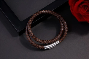 Detail of dark brown braided leather bracelet with silver stainless steel magnetic clasp