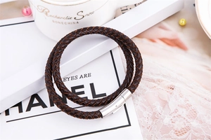 Detail of dark brown braided leather bracelet with a polished silver magnetic clasp