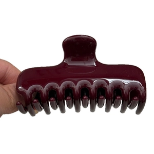 Polished burgundy claw clip with multi-tooth design for elegant hair styling